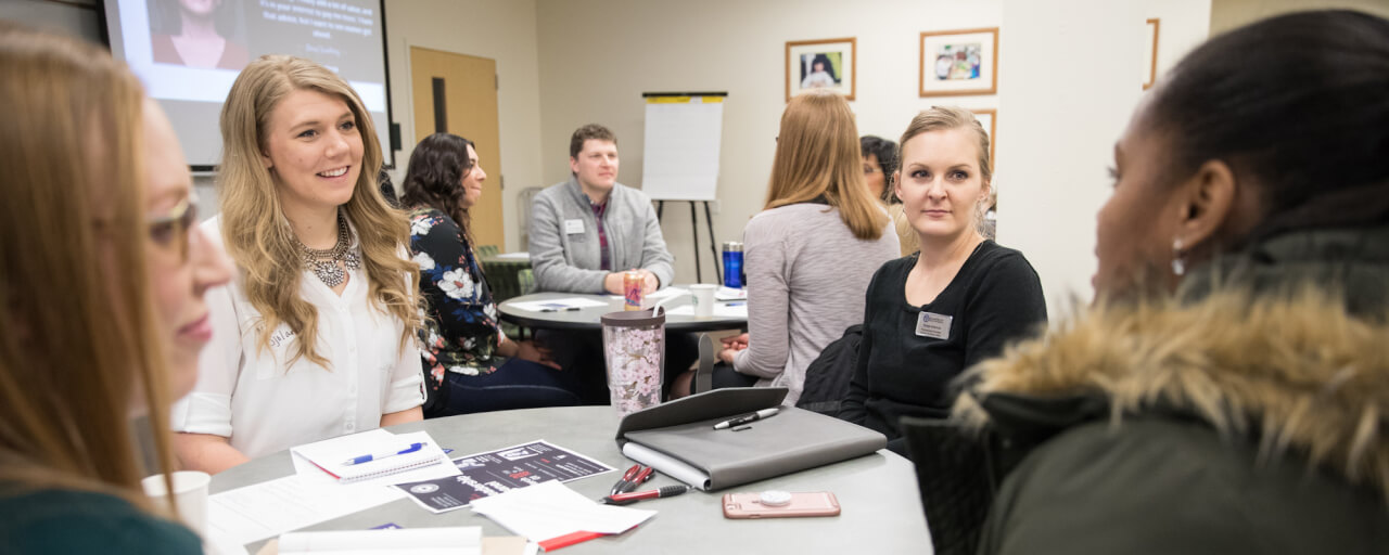 A gathering of young professionals in higher education